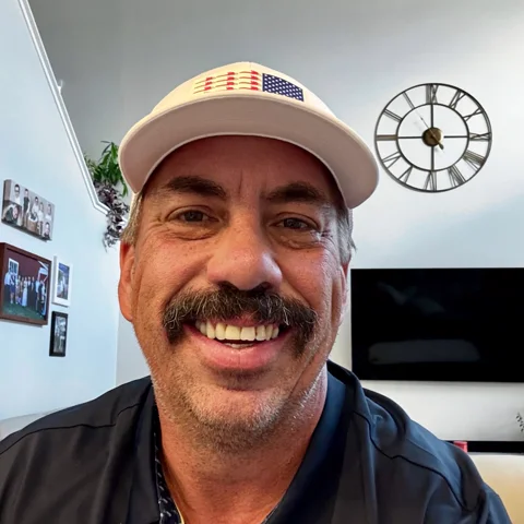 Rob Frakes, Ledge Rock HOA board member, smiling in a white cap